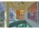 Screened porch with view of kitchen and backyard at 19247 Sw 98Th Loop, Dunnellon, FL 34432