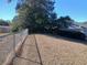 View of the expansive backyard enclosed by a chain-link fence with mature trees beyond at 19950 Ibis Ct, Dunnellon, FL 34432