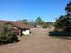 View of the backyard from the edge of the property, adjacent house also visible at 19950 Ibis Ct, Dunnellon, FL 34432