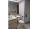 Standard bathroom featuring a single sink vanity and a toilet with assistive grab bars at 19950 Ibis Ct, Dunnellon, FL 34432