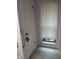 Bathroom with a window dressed with white curtains next to a closet at 19950 Ibis Ct, Dunnellon, FL 34432