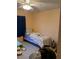 Simple bedroom with single bed and ceiling fan at 19950 Ibis Ct, Dunnellon, FL 34432