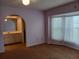 Bedroom featuring a carpeted floor and a large bay window with curtains at 19950 Ibis Ct, Dunnellon, FL 34432