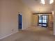 Open dining area with a chandelier, sliding door access to the exterior, and neutral carpet at 19950 Ibis Ct, Dunnellon, FL 34432