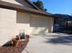 Attached two-car garage with a beige door, plus partial view of screened in enclosure at 19950 Ibis Ct, Dunnellon, FL 34432