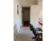 Bright hallway with carpet and a rocking chair at 19950 Ibis Ct, Dunnellon, FL 34432