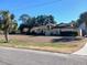 One-story home with brown roof and large yard at 19950 Ibis Ct, Dunnellon, FL 34432