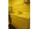 Laundry room with yellow walls and side-by-side washer and dryer at 19950 Ibis Ct, Dunnellon, FL 34432