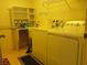 Laundry room with yellow walls and side-by-side washer and dryer at 19950 Ibis Ct, Dunnellon, FL 34432