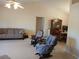 Spacious living room with seating and a view into dining area at 19950 Ibis Ct, Dunnellon, FL 34432