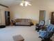 Bright living room featuring a sofa, rocking chair, and ample space at 19950 Ibis Ct, Dunnellon, FL 34432