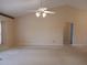 Large living room with neutral carpet, vaulted ceiling, and decorative wallpaper border at 19950 Ibis Ct, Dunnellon, FL 34432