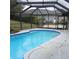 A view of the screened-in pool and deck area, with access to the backyard and house at 19950 Ibis Ct, Dunnellon, FL 34432