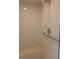 An accessible shower with a built-in seat and a handheld shower head at 19950 Ibis Ct, Dunnellon, FL 34432