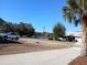 Street view of the property showcasing a glimpse of the nearby lake at 19950 Ibis Ct, Dunnellon, FL 34432