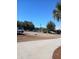 Lake view from a residential street with palm trees and a parked car at 19950 Ibis Ct, Dunnellon, FL 34432