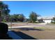 Residential street view with houses and mature trees near a body of water at 19950 Ibis Ct, Dunnellon, FL 34432