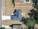 An aerial view of a gray roof house with a long driveway in a community with sparse vegetation at 201 Locust Rd, Ocala, FL 34472