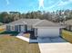 New construction home, gray exterior, two-car garage, and driveway at 201 Locust Rd, Ocala, FL 34472