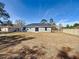 Large backyard with a home featuring a gray exterior and a grassy area at 201 Locust Rd, Ocala, FL 34472