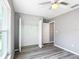 Neutral bedroom features vinyl floors, ceiling fan, and closet with shelving at 201 Locust Rd, Ocala, FL 34472