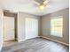 Well-lit bedroom with double door closet and wood-look floors at 201 Locust Rd, Ocala, FL 34472