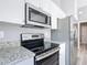 Stainless steel oven and microwave in a modern kitchen with granite countertops at 201 Locust Rd, Ocala, FL 34472