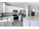 Close-up of a modern kitchen with stainless steel appliances and granite countertops at 201 Locust Rd, Ocala, FL 34472