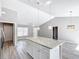 Kitchen island with granite countertop and white shaker cabinets at 201 Locust Rd, Ocala, FL 34472