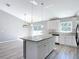 Kitchen with an island, granite countertops, and ample natural light at 201 Locust Rd, Ocala, FL 34472