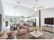 Bright, open-concept living room with a ceiling fan, dining area and modern kitchen at 201 Locust Rd, Ocala, FL 34472