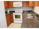 Galley style kitchen with wood cabinets and stainless steel appliances at 21465 Sw Honeysuckle St, Dunnellon, FL 34431