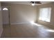 Bright living room with tile floors and ceiling fan at 21465 Sw Honeysuckle St, Dunnellon, FL 34431