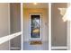 Front entry with a glass door, screen enclosure, and a welcoming doormat at 24 Pine Course Pl, Ocala, FL 34472