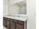 Bathroom with double vanity and large mirror at 27 Hickory Course Ln, Ocala, FL 34472