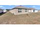 Side view of tan house with windows and grassy yard at 27 Hickory Course Ln, Ocala, FL 34472