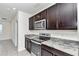 Kitchen features dark wood cabinets and granite countertops at 27 Hickory Course Ln, Ocala, FL 34472