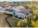 Aerial view of the home and backyard, featuring a patio, garden, and black metal fence at 3690 Nw 56Th Ave, Ocala, FL 34482