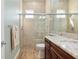 Bathroom features a tiled shower with glass doors and a granite countertop vanity at 3690 Nw 56Th Ave, Ocala, FL 34482