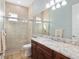 Bathroom features a tiled shower with glass doors and a granite countertop vanity at 3690 Nw 56Th Ave, Ocala, FL 34482