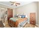 Guest bedroom featuring ceiling fan, wood look tile floors, closet, and sliding barn door at 3690 Nw 56Th Ave, Ocala, FL 34482