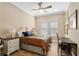 Guest bedroom featuring ceiling fan, two windows, wood look tile floors, and closet at 3690 Nw 56Th Ave, Ocala, FL 34482