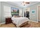 Bedroom featuring wood floors, a large bed and a walk-in closet at 3690 Nw 56Th Ave, Ocala, FL 34482