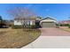 Charming two-story home featuring a well-manicured lawn, stone accents, and neutral toned exterior at 3690 Nw 56Th Ave, Ocala, FL 34482