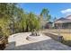 Circular stone fire pit set in the backyard surrounded by trees and vegetation at 3690 Nw 56Th Ave, Ocala, FL 34482