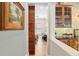 Hallway featuring accent painting, sliding barn door and view of the guest bedroom at 3690 Nw 56Th Ave, Ocala, FL 34482