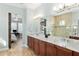 View of the bathroom with dual sinks, granite countertops, and a door to the bedroom at 3690 Nw 56Th Ave, Ocala, FL 34482