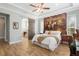 Bright main bedroom featuring tray ceilings, barn door, and painted horse mural above the bed at 3690 Nw 56Th Ave, Ocala, FL 34482