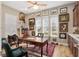 A home office with hardwood floors, desk and artwork on the wall at 3690 Nw 56Th Ave, Ocala, FL 34482