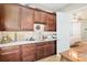 Office area with custom cabinets, sink, and doorway leading into bedroom at 3690 Nw 56Th Ave, Ocala, FL 34482